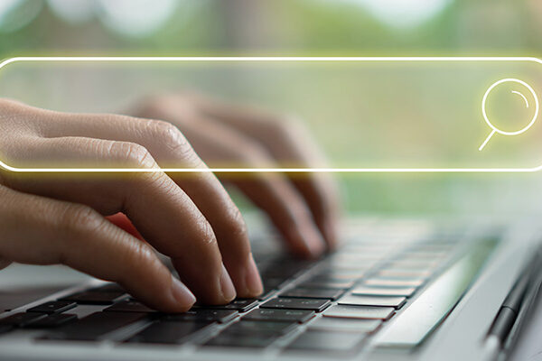 typing search query on laptop